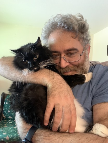 This is my LacieMoonshdow. Being hugged by my brother atom. Lacie is a long-haired black and white tuxedo cat, and I love her so! Love my brother too.