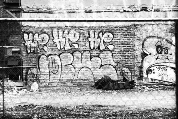 Black and white photograph of graffiti with toast.