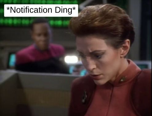 Kira and Ben are in Ops when a computer makes a notification ding.