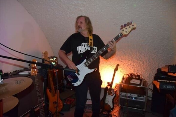 Yours truly playing a blueburst P style bass guitar at a local jam session. Note the Sex Pistols t-shirt, stripper inlays, and cheesy yellow POLICE LINE DO NOT CROSS strap.