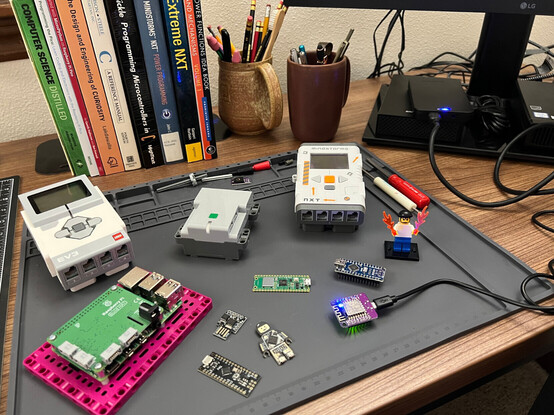 A photo showing a few of the microcontroller boards and LEGO hubs that I'm learning to program.