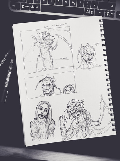 a photo of a sketchbook page with several sketches of an alien guy and a human woman. two sketches a placed into a frame, the others are placed loosely around it.