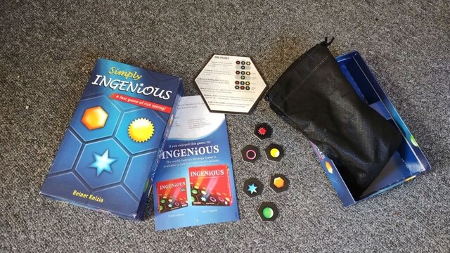 The box and components for the game "Simply Ingenious"
