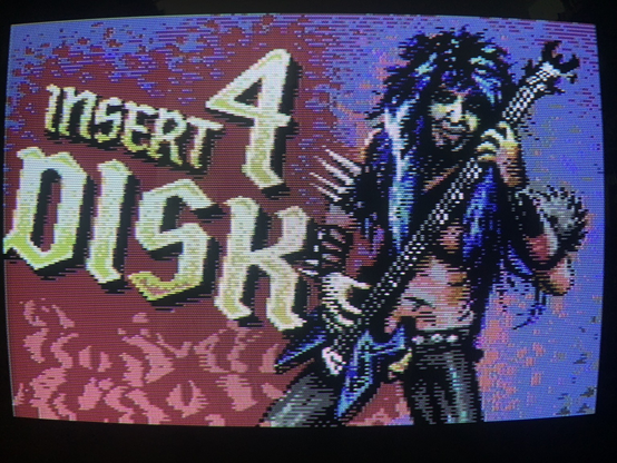 „Insert Disk 4“ screen with a drawing of a heavy metal guitarist