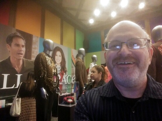 Me in an the first exhibit room. Behind me, mannequins with costumes from the show and photos of the cast members.
