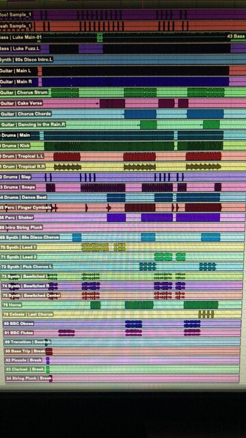 this is a photo of a computer screen with a large pro tools session on it. so many audio waveforms in all different colors!