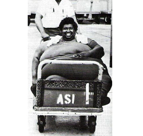 Photo from the 1988 Guiness Book of World Records: "HEAVIEST LIVING MAN. T.J. Albert Jackson (b. 1941 in Canton, Miss) known as 'Fat Albert', has a 120-in chest, 115-in waist, 70-in thighs and 29 1/2-in neck. His weight varies between 872 and 898 ib. He spends his time being transported as 'overweight baggage' from show place to show place, all over the US for Four C. Productions, Inc, of Miami (Wide World Photos)"