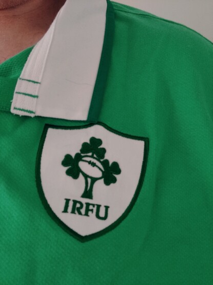 Close up of an Irish Rugby jersey badge showing the logo and initials IRFU