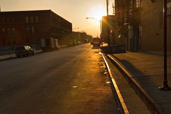 A photograph of Fulton Street in Fulton market Chicago when the sun is setting making everything golden. The photo was taken in 2006, the area looks much different now.