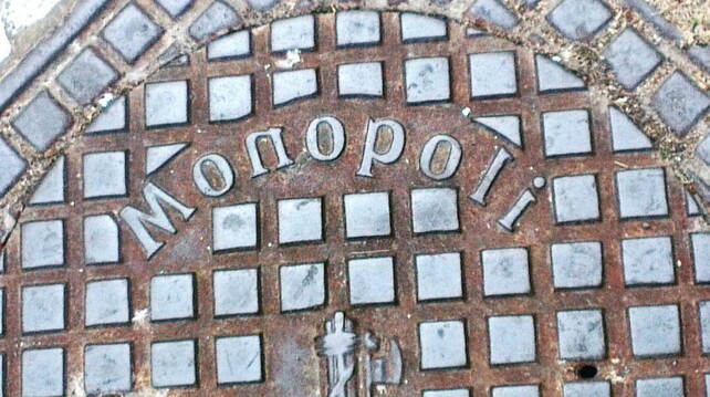 A picture of a manhole cover in Monopoly, Italy, but all the letters are mirrored