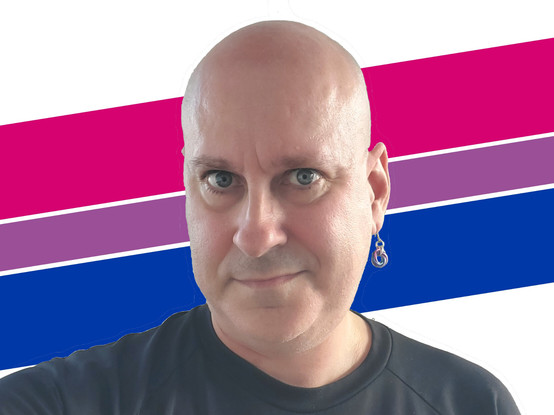 Me, a bald, middle-aged white guy with blue eyes, wearing a black t-shirt and a single earring as described in the post. There are bi pride color stripes behind my head, at a slight angle giving a dynamic, "whoosh" kind of feel.