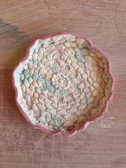 Bisque fired and underglaze color applied to ring dish before glazing and firing again