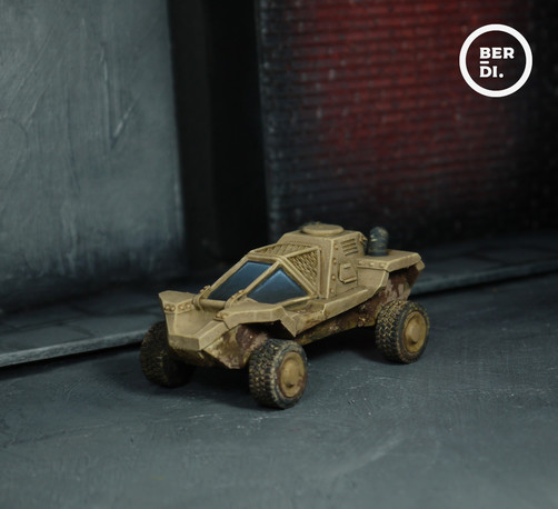Wargame model. Compact military style vehicle. Angled panels and painted desert tan colour. Wheels and underside coated in dirt and mud.