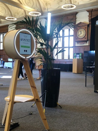 UKFIET Conference projected with wooden clock on the wall inside Examination Schools, Oxford