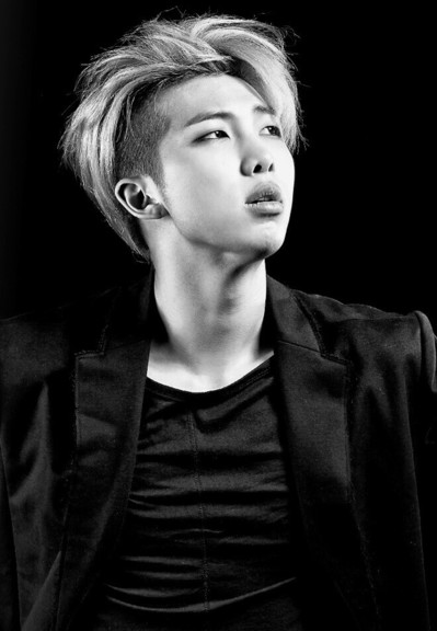 black and white of namjoon, undercut and wild hair, wearing black satiny shirt and a black blazer, looking hot
