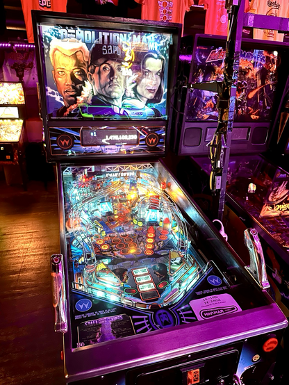 Demolition Man pinball machine, front view. The game has been modeed with light blue leds.