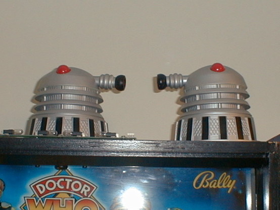 A top of Doctor Who pinball machine's cabinet with two Dalek toppers on it.