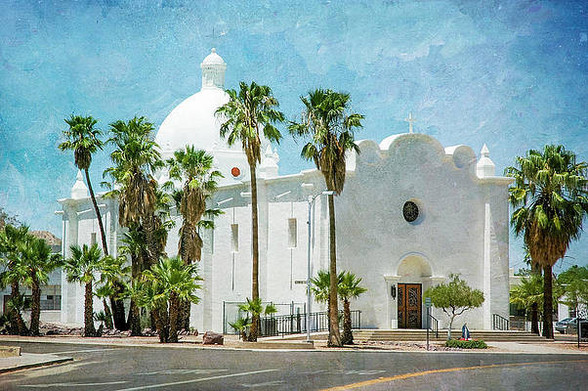 White stucco Catholic church in Mission style, Arizona. Image glows with white architecture.