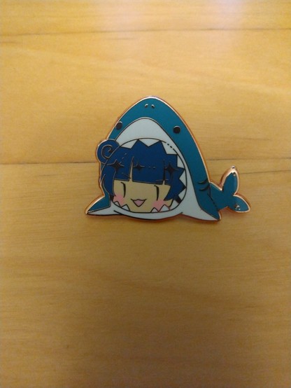 Pin in the shape of Yohane in the mouth of a shark.