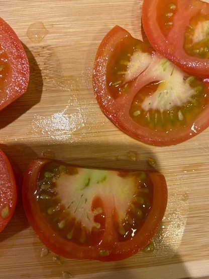 Are these “green things” in the middle of the white part of the tomato bad?