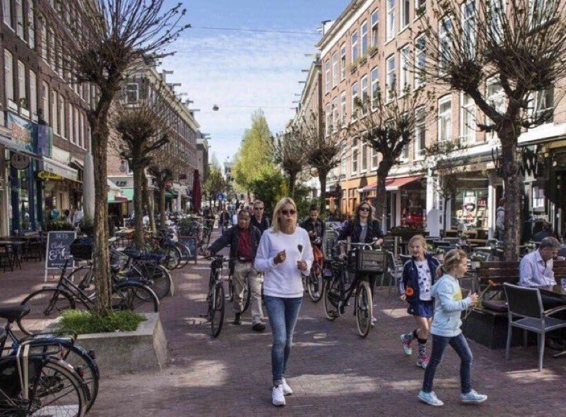 Same Amsterdam street filled with people, no cars