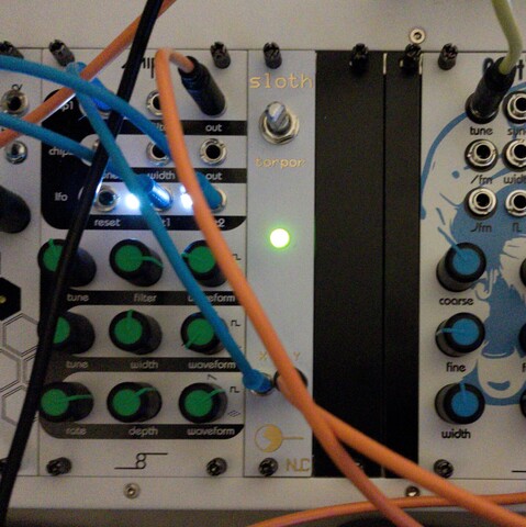 Eurorack synth, with several modules from left to right: Cellz, Chipz, NLC Sloth, Capt'n Big O. Cables in front.