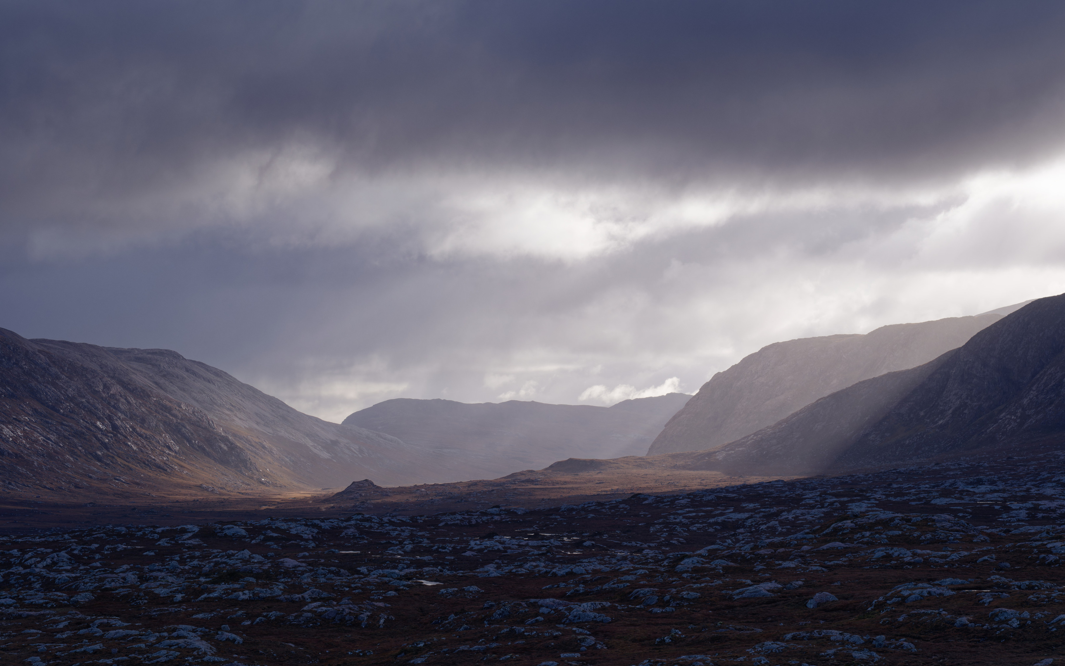 Dramatic side-light on Cnoc'n'Lochan (Karst) landscape - gneiss interspersed with water, Strath Dionard, Sutherland