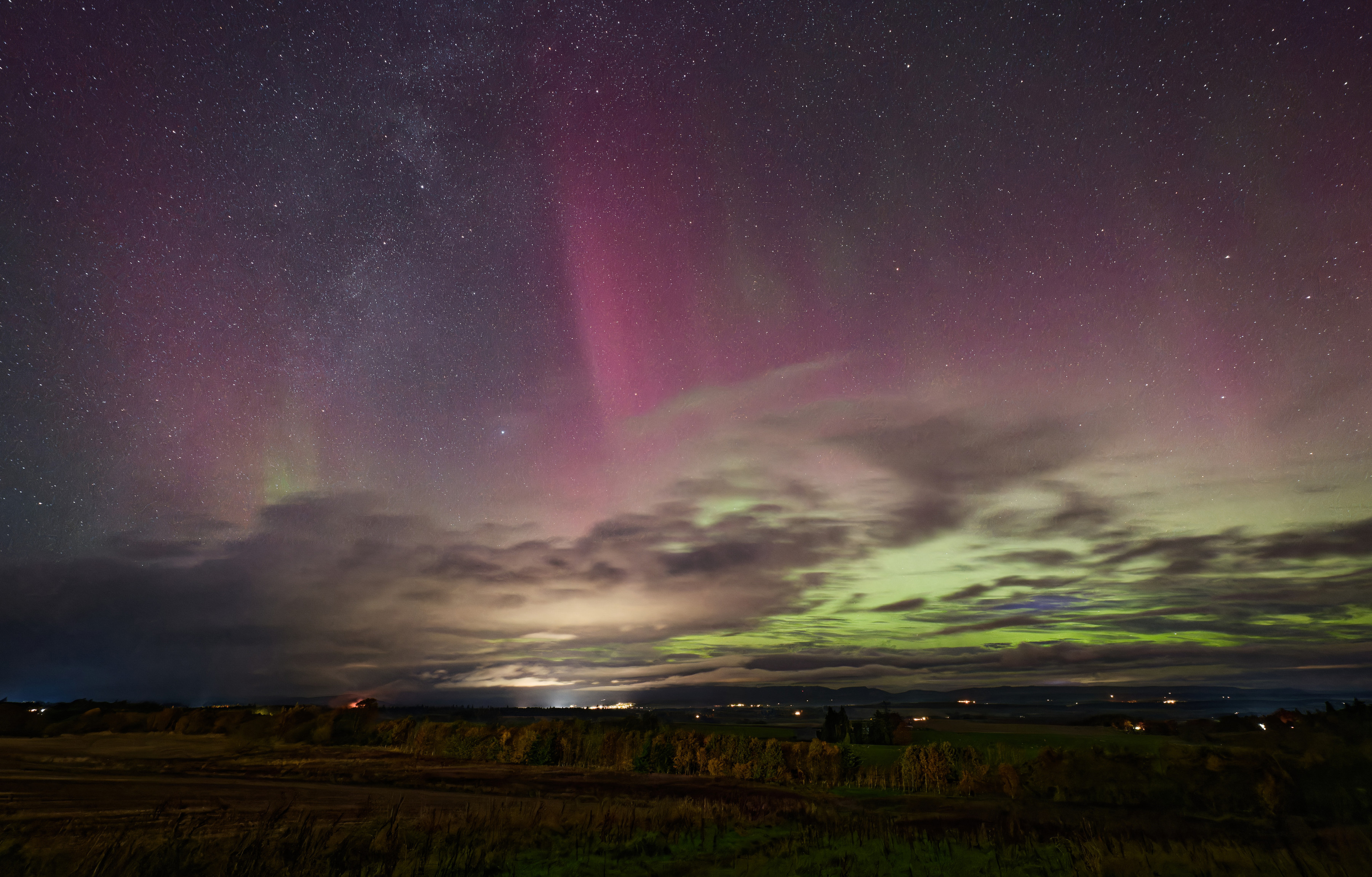 Brilliant aurora display, bright purple rays and green 