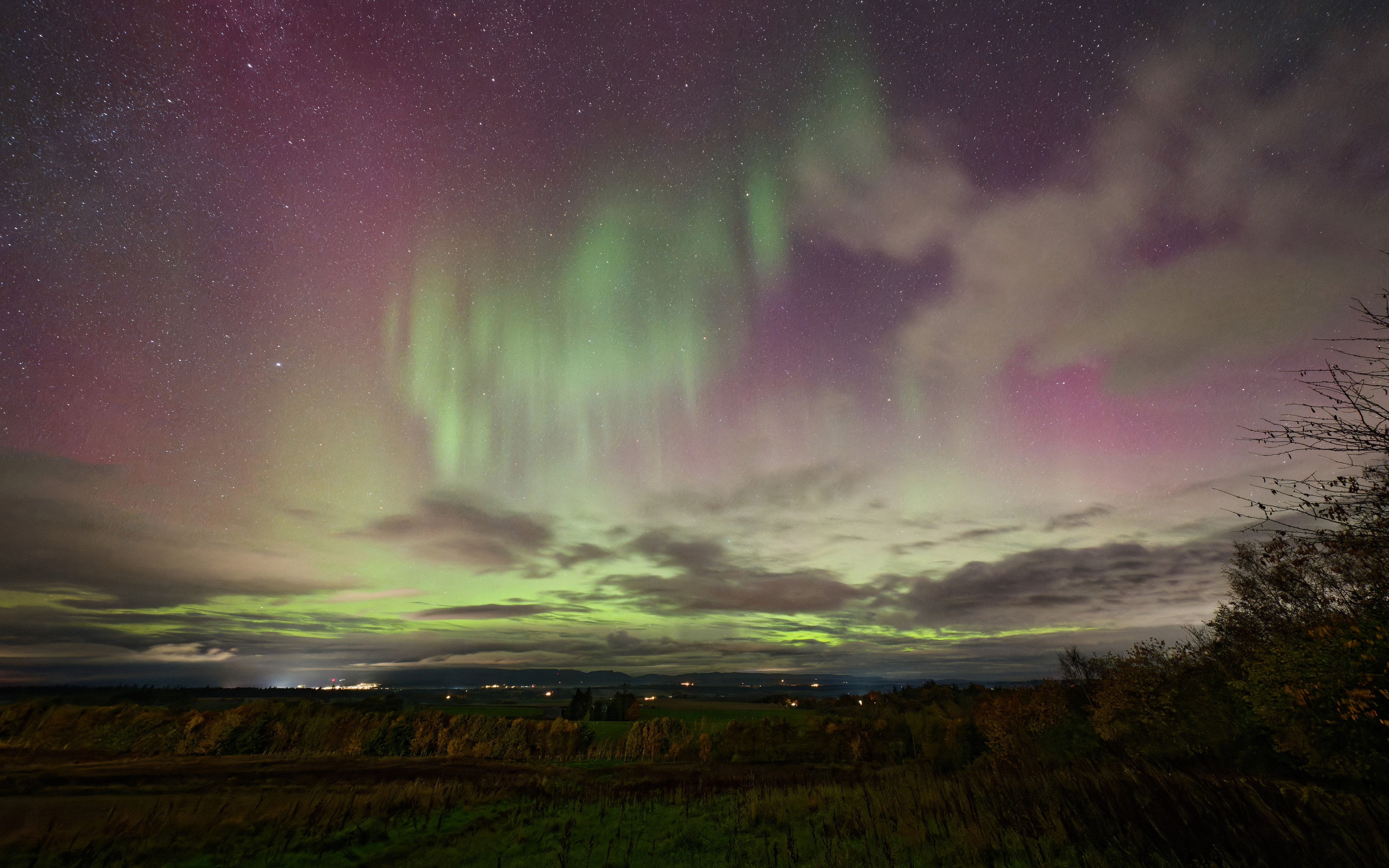 Brilliant aurora display, bright purple rays and green 