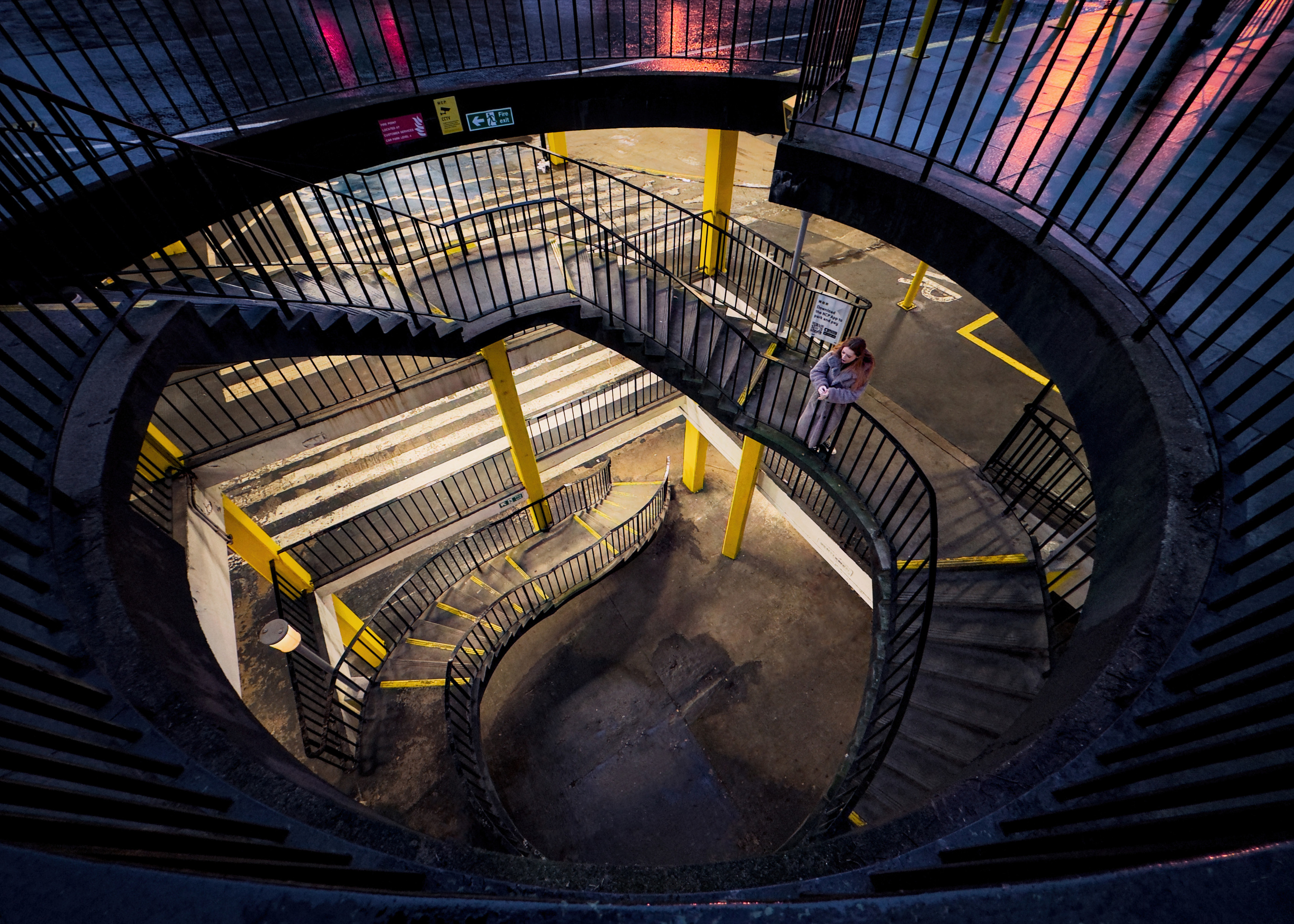 A view down the NCP car park in Castle Terrace, a lady standing part-way down the descending stairs