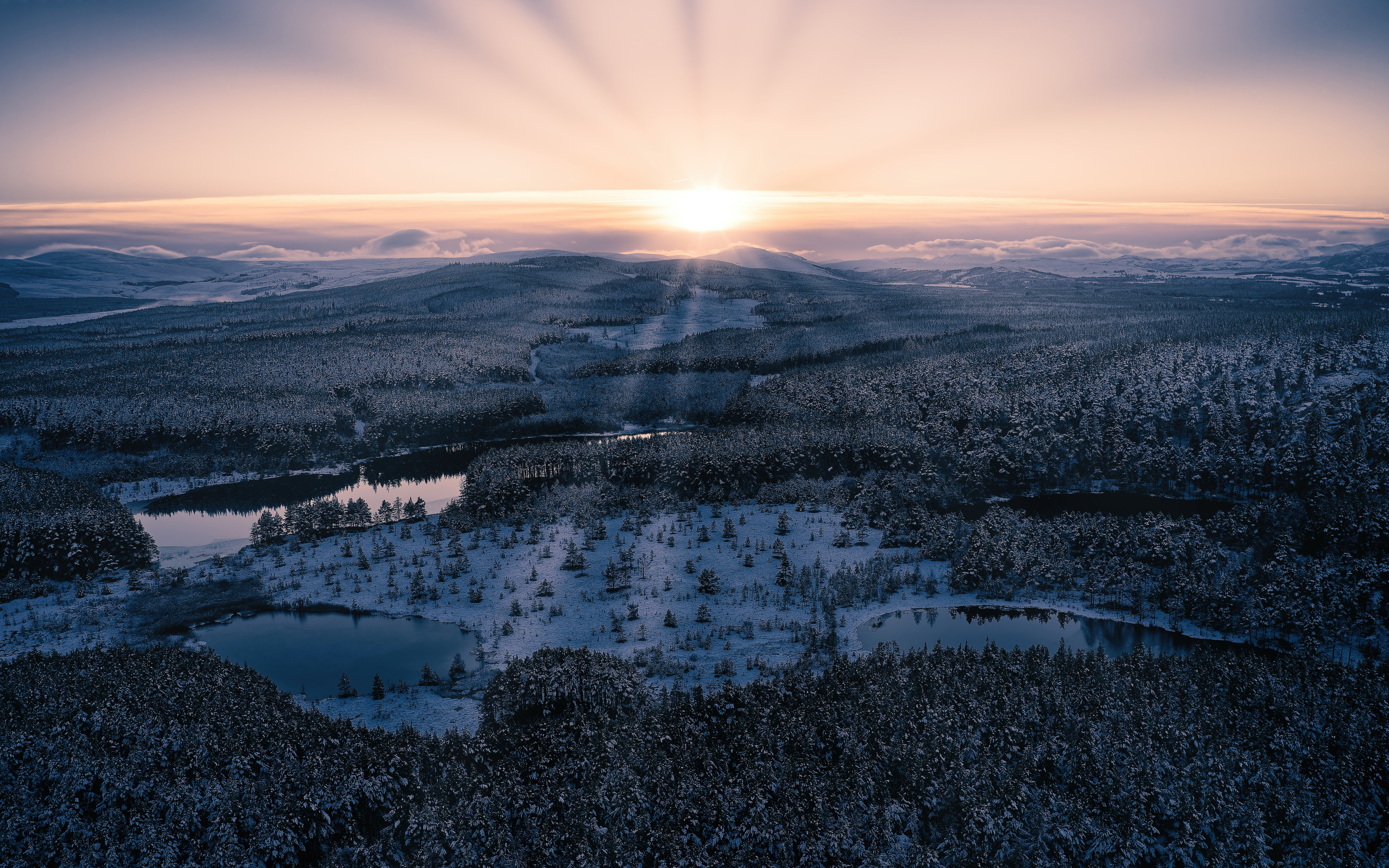 Sunset light reflecting in the Uath Lochans near Aviemore in the Cairngorms, taken by drone.