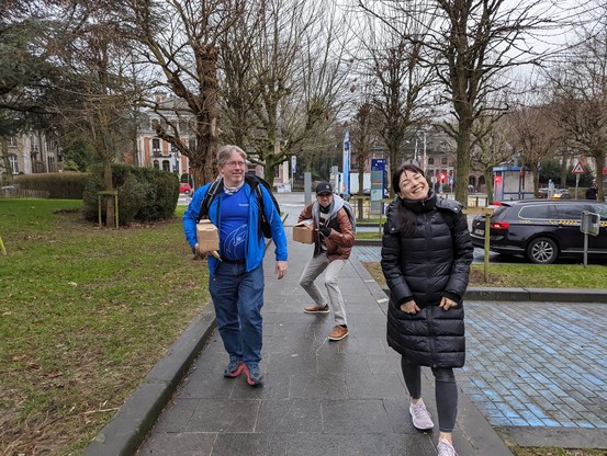 Members of Team Thunderbird on their way to Building K to set up the stand on a grey morning in Brussels, with one trying to be very stealthy on their approach!