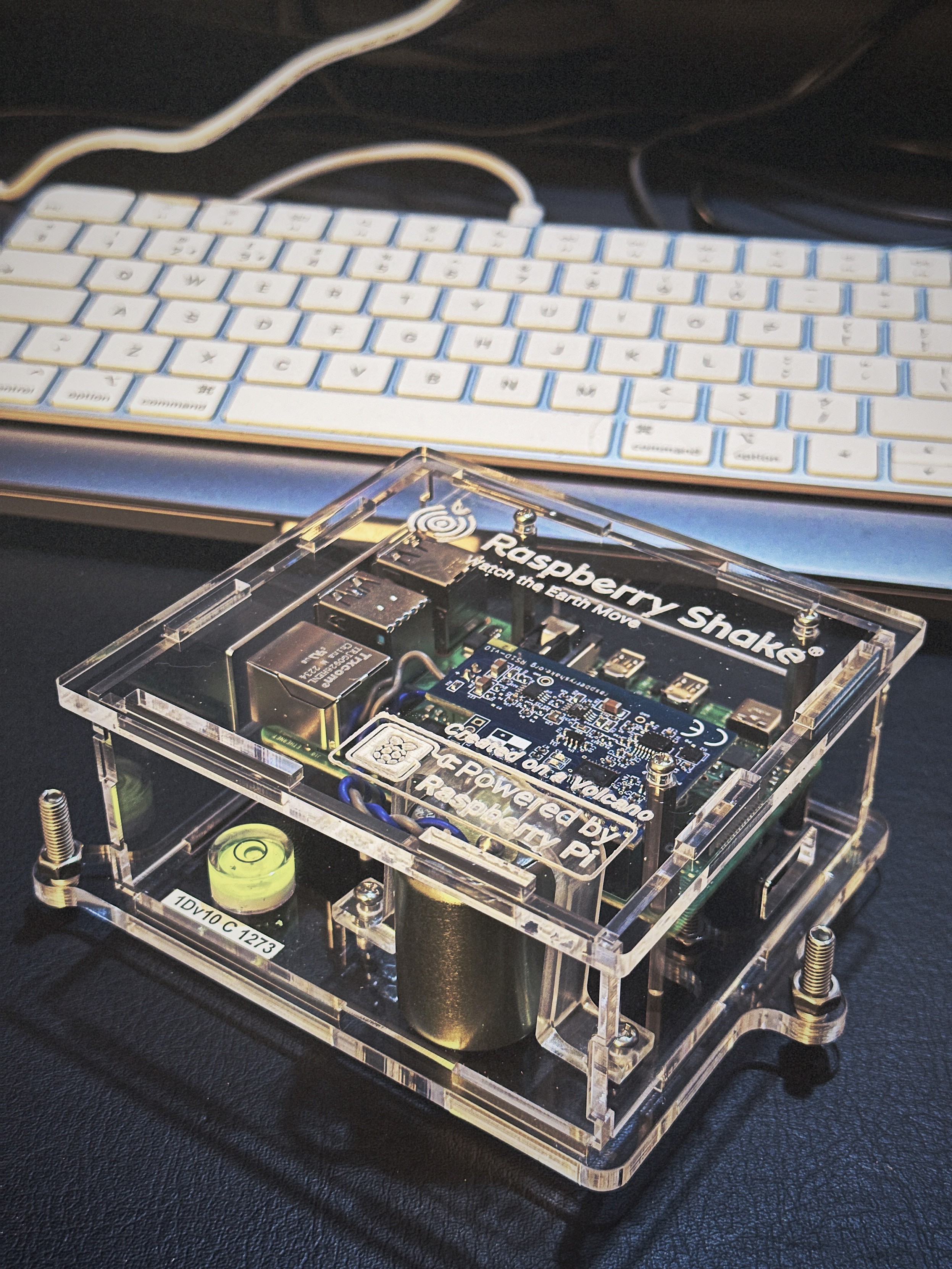 Closeup photo of a small raspberry Shake seismometer on a desk