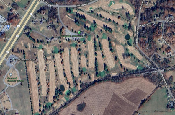 An aerial overhead view of a golf course in Greeneville, Tennessee. Many of the holes appear to be very similar to each other, with straight fairways and few to no hazards. There are a couple of dog leg holes.