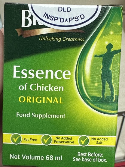 A box of Essence of Chicken Original food supplement, with health claims such as Fat Free, No Added Preservative, and No Added Salt. There's an image of a person with arms outstretched with light graphics suggesting energy or vitality.
