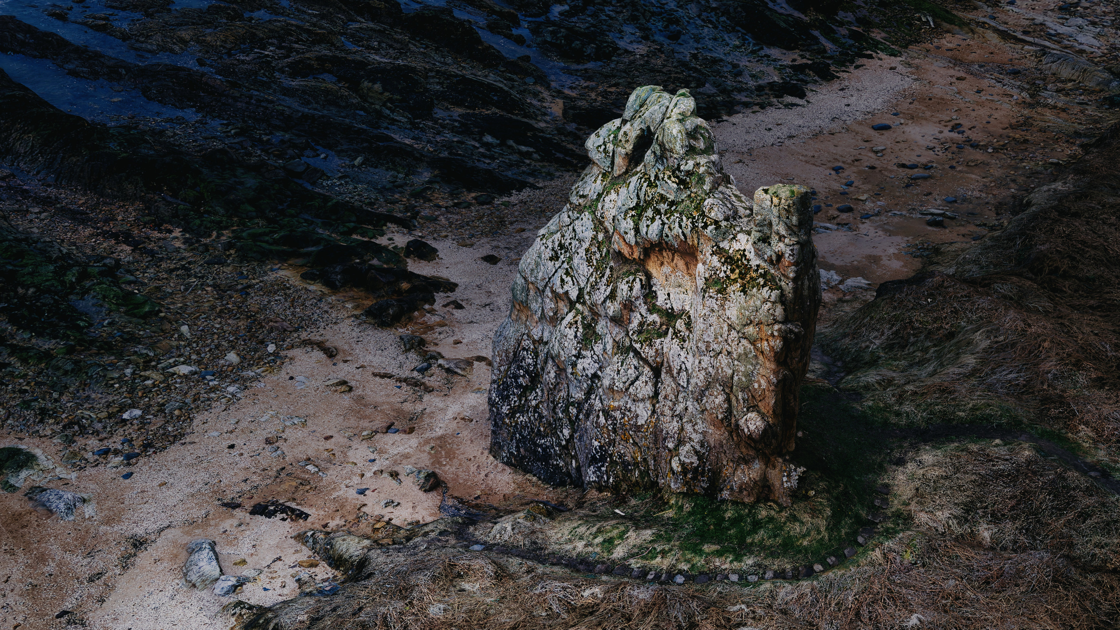 A 3D model from 2.2Gpx of data showing the Maiden Rock sandstone seastack outside St Andrews, Scotland, relit and rendered in Blender and finished in LuminarAI.