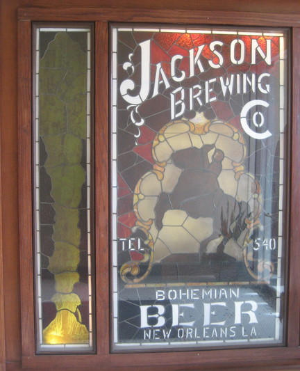 Stained glass window from c. 1890s for local beer brewery. 

At center is a silhouette of a man on horseback, referencing the statue of General Andrew Jackson in Jackson Square, New Orleans.   

Text at top: "JACKSON BREWING CO" .   
Text lower center: "TEL 540". 
Text at bottom: "BOHEMIAN BEER - NEW ORLEANS LA". 