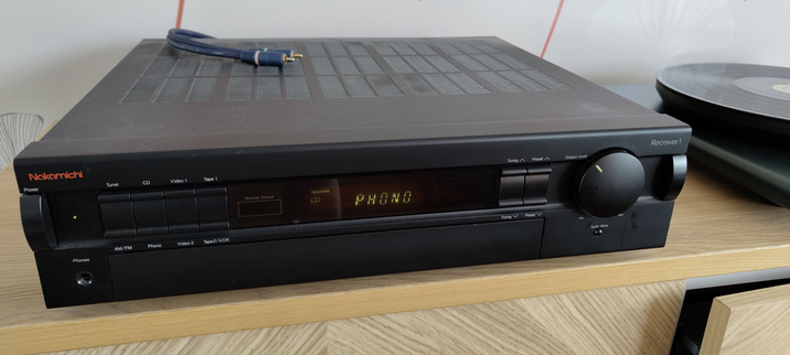 90s Nakamichi receiver sitting next to a turntable.