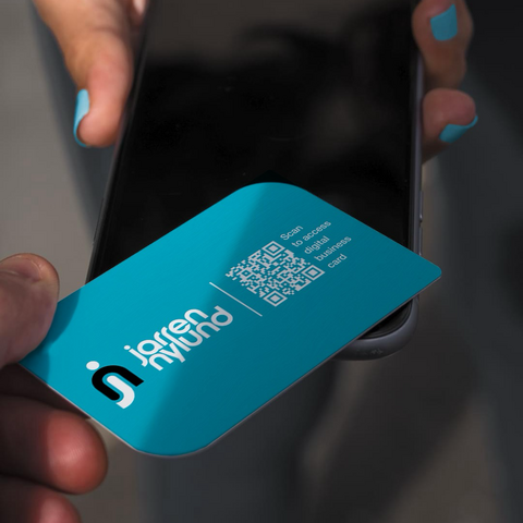 A photo of the NFC business card being tapped onto another person’s iPhone.