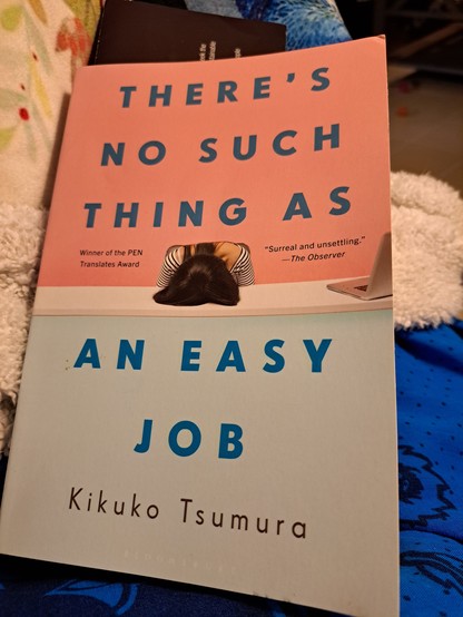 A pink and light blue cover announces There's No Such Thing As An Easy Job, by Kikuko Tsmura. The translator is noted on the back cover, Polly Barton. 