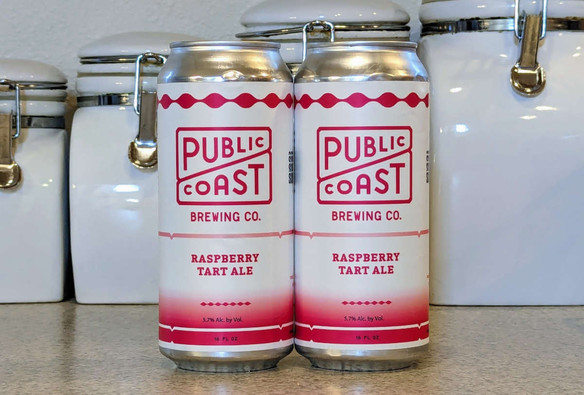 Two cans of Raspberry Tart Ale from Public Coast Brewing of Cannon Beach, Oregon. The label design is a simple two-tone motif with white and pink as the two main colors.