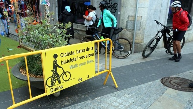 Cartell adreçat als ciclistes a l'entrada del carrer Nou de Girona (ACN/Xavier Pi)