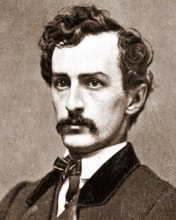 An image of John Wilkes Booth — a white man with a turned down mustache and wavy hair.  He is the Confederate sympathizer who assassinated Abraham Lincoln. 