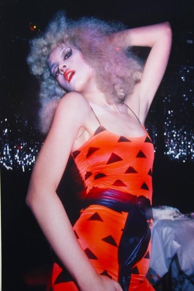 Waring Abbott - Studio 54 - 70s

Person in a disco wearing an orange outfit and curly white hair

