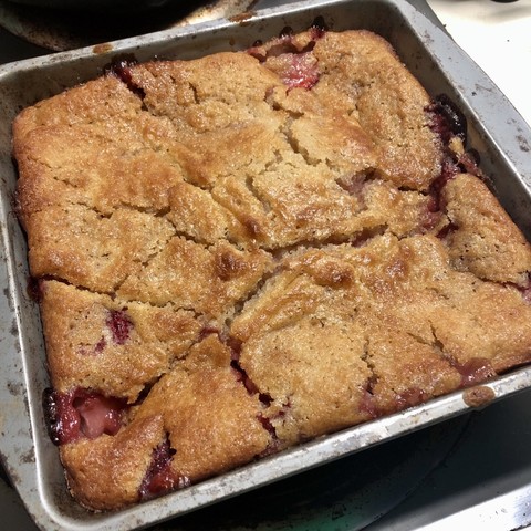 a strawberry cobbler in a square metal pan