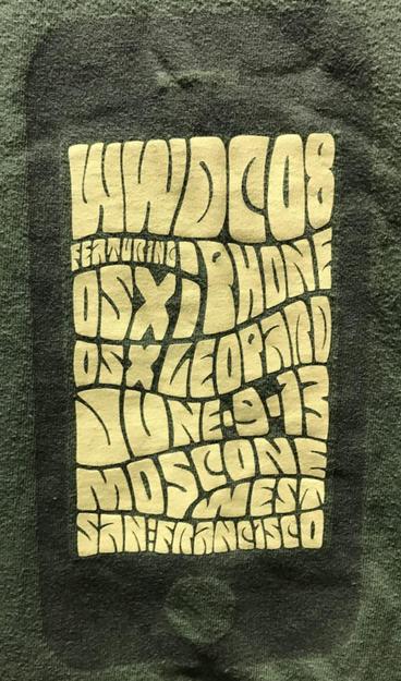 Image of a T-shirt sold during WWDC 2008 with psychedelic writing saying “WWDC08
Featuring OSX iPhone
OSX Leopard
June 9-13
Moscone West
San Francisco”
