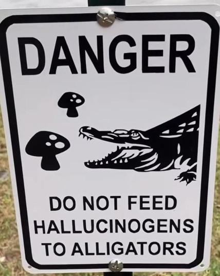 A warning sign displaying an alligator and mushrooms, stating 
