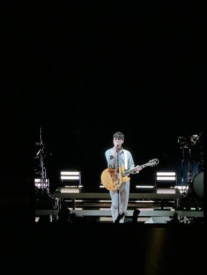 A photo of Ezra singing at the Vampire Weekend live show.