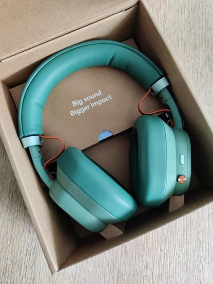 Fairphone Fairbuds XL headphone in its opened box, with the text 