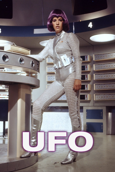 a woman with purple hair wearing a silver body suit standing in a futuristic moon base with the caption UFO, from the Gerry Anderson TV show UFO.